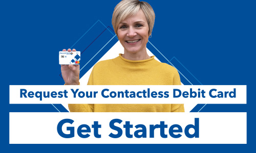 Decorah Bank employee Liz Roe holding up a Decorah Bank debit Card